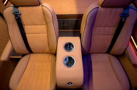 Comfortable interior of a passenger bus with soft seats Stock Photos