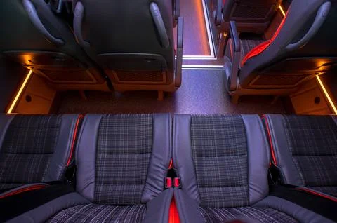 Comfortable interior of a passenger bus with soft seats Stock Photos