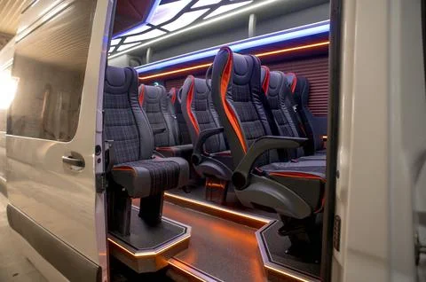 Comfortable interior of a passenger bus with soft seats Stock Photos