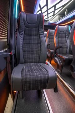 Comfortable interior of a passenger bus with soft seats Stock Photos