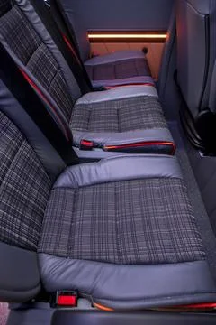 Comfortable interior of a passenger bus with soft seats Stock Photos