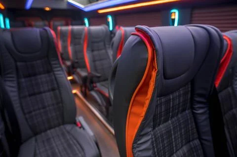 Comfortable interior of a passenger bus with soft seats Stock Photos