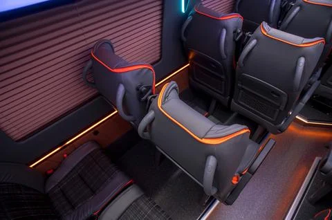 Comfortable interior of a passenger bus with soft seats Stock Photos