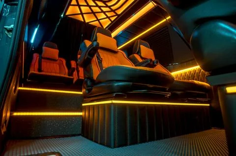 Comfortable interior of a passenger bus with soft seats Stock Photos