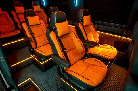 Comfortable interior of a passenger bus with soft seats Stock Photos