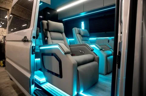 Comfortable interior of a passenger bus with soft seats Stock Photos