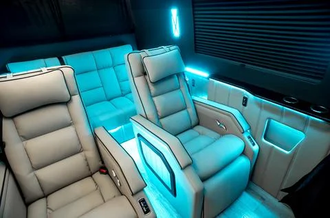 Comfortable interior of a passenger bus with soft seats Stock Photos