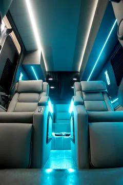 Comfortable interior of a passenger bus with soft seats Stock Photos
