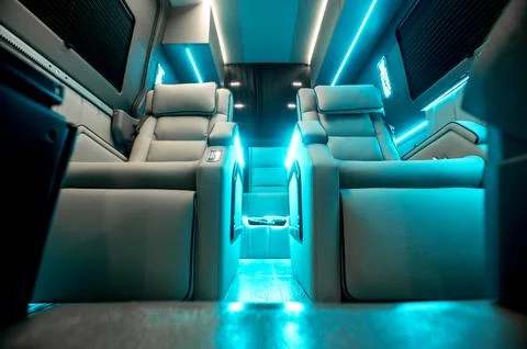 Comfortable interior of a passenger bus with soft seats Stock Photos