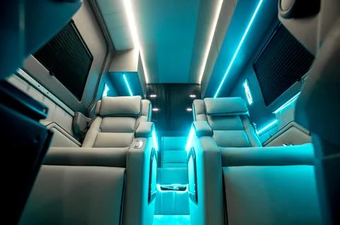 Comfortable interior of a passenger bus with soft seats Stock Photos