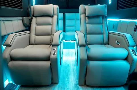 Comfortable interior of a passenger bus with soft seats Stock Photos