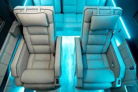 Comfortable interior of a passenger bus with soft seats Stock Photos