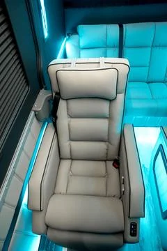 Comfortable interior of a passenger bus with soft seats Stock Photos