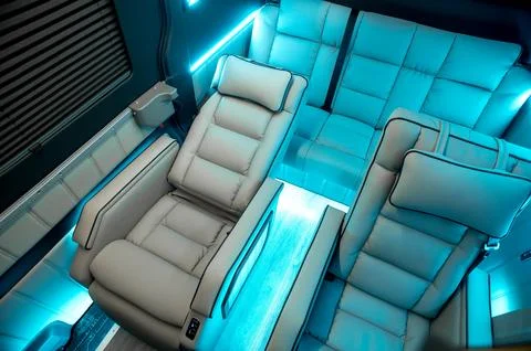 Comfortable interior of a passenger bus with soft seats Stock Photos