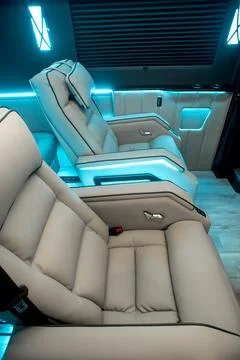 Comfortable interior of a passenger bus with soft seats Stock Photos
