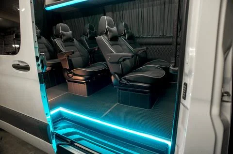 Comfortable interior of a passenger bus with soft seats Stock Photos