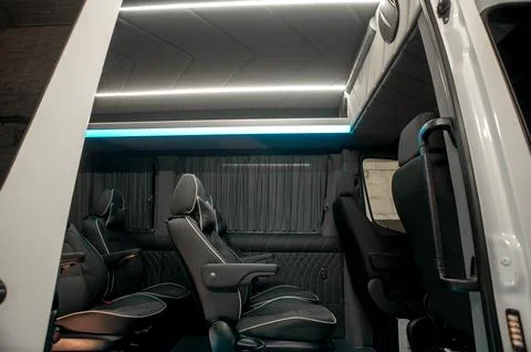 Comfortable interior of a passenger bus with soft seats Stock Photos