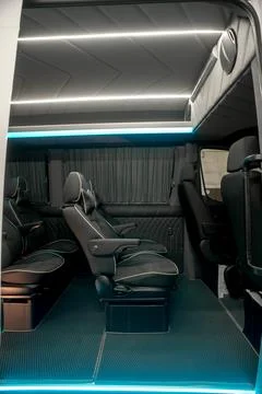 Comfortable interior of a passenger bus with soft seats Stock Photos