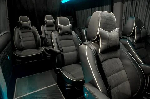 Comfortable interior of a passenger bus with soft seats Stock Photos