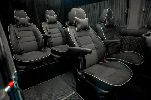 Comfortable interior of a passenger bus with soft seats Stock Photos