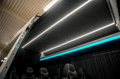 Comfortable interior of a passenger bus with soft seats Stock Photos