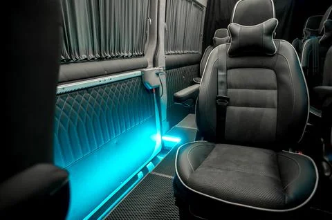 Comfortable interior of a passenger bus with soft seats Stock Photos