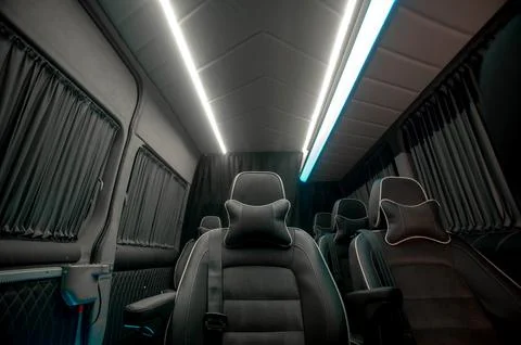 Comfortable interior of a passenger bus with soft seats Stock Photos