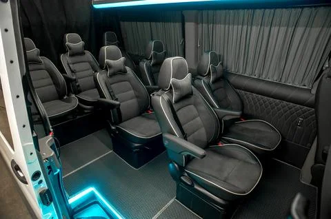 Comfortable interior of a passenger bus with soft seats Stock Photos