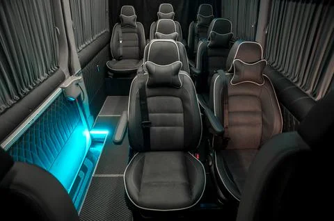 Comfortable interior of a passenger bus with soft seats Stock Photos