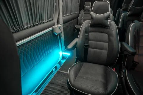 Comfortable interior of a passenger bus with soft seats Stock Photos