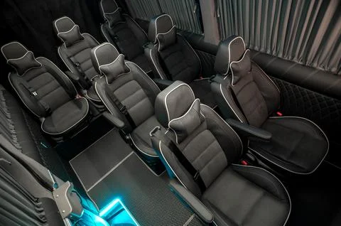 Comfortable interior of a passenger bus with soft seats Stock Photos