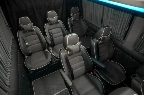 Comfortable interior of a passenger bus with soft seats Stock Photos