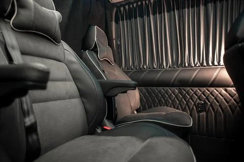 Comfortable interior of a passenger bus with soft seats Stock Photos