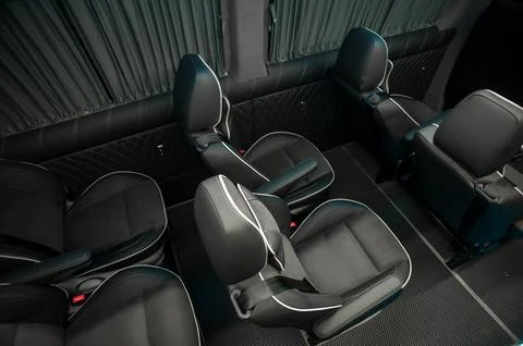 Comfortable interior of a passenger bus with soft seats Stock Photos
