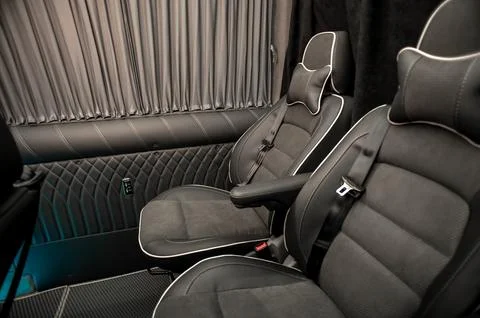 Comfortable interior of a passenger bus with soft seats Stock Photos