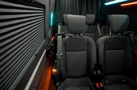 Comfortable interior of a passenger bus with soft seats Stock Photos
