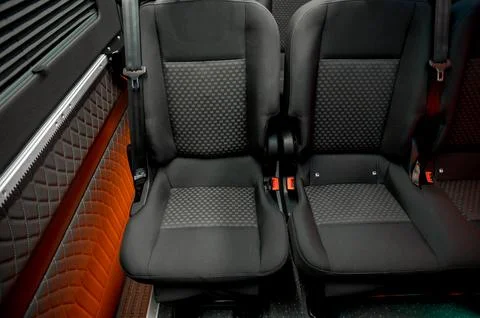 Comfortable interior of a passenger bus with soft seats Stock Photos