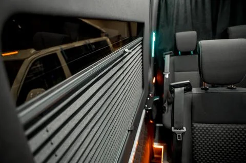 Comfortable interior of a passenger bus with soft seats Stock Photos