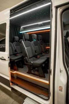Comfortable interior of a passenger bus with soft seats Stock Photos