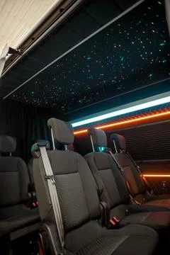 Comfortable interior of a passenger bus with soft seats Stock Photos