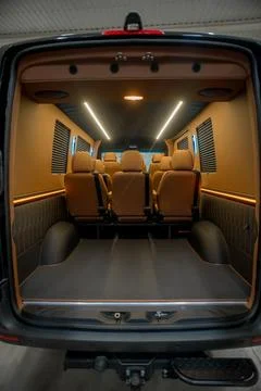 Comfortable interior of a passenger bus with soft seats Stock Photos