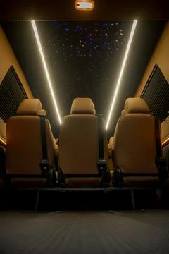 Comfortable interior of a passenger bus with soft seats Stock Photos