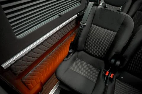 Comfortable interior of a passenger bus with soft seats Stock Photos