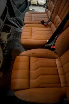 Comfortable interior of a passenger bus with soft seats Stock Photos