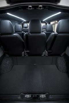 Comfortable interior of a passenger bus with soft seats Stock Photos