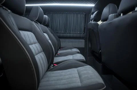 Comfortable interior of a passenger bus with soft seats Stock Photos