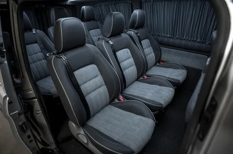 Comfortable interior of a passenger bus with soft seats Stock Photos