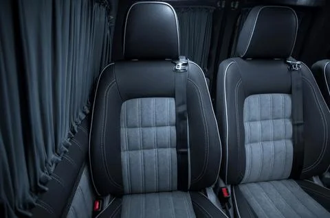 Comfortable interior of a passenger bus with soft seats Stock Photos