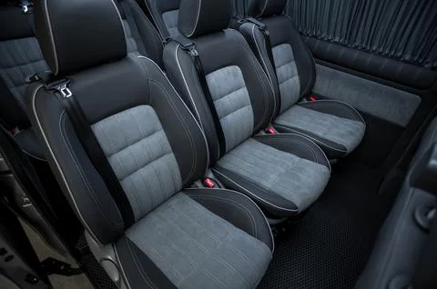 Comfortable interior of a passenger bus with soft seats Stock Photos