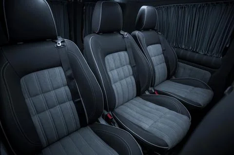 Comfortable interior of a passenger bus with soft seats Stock Photos